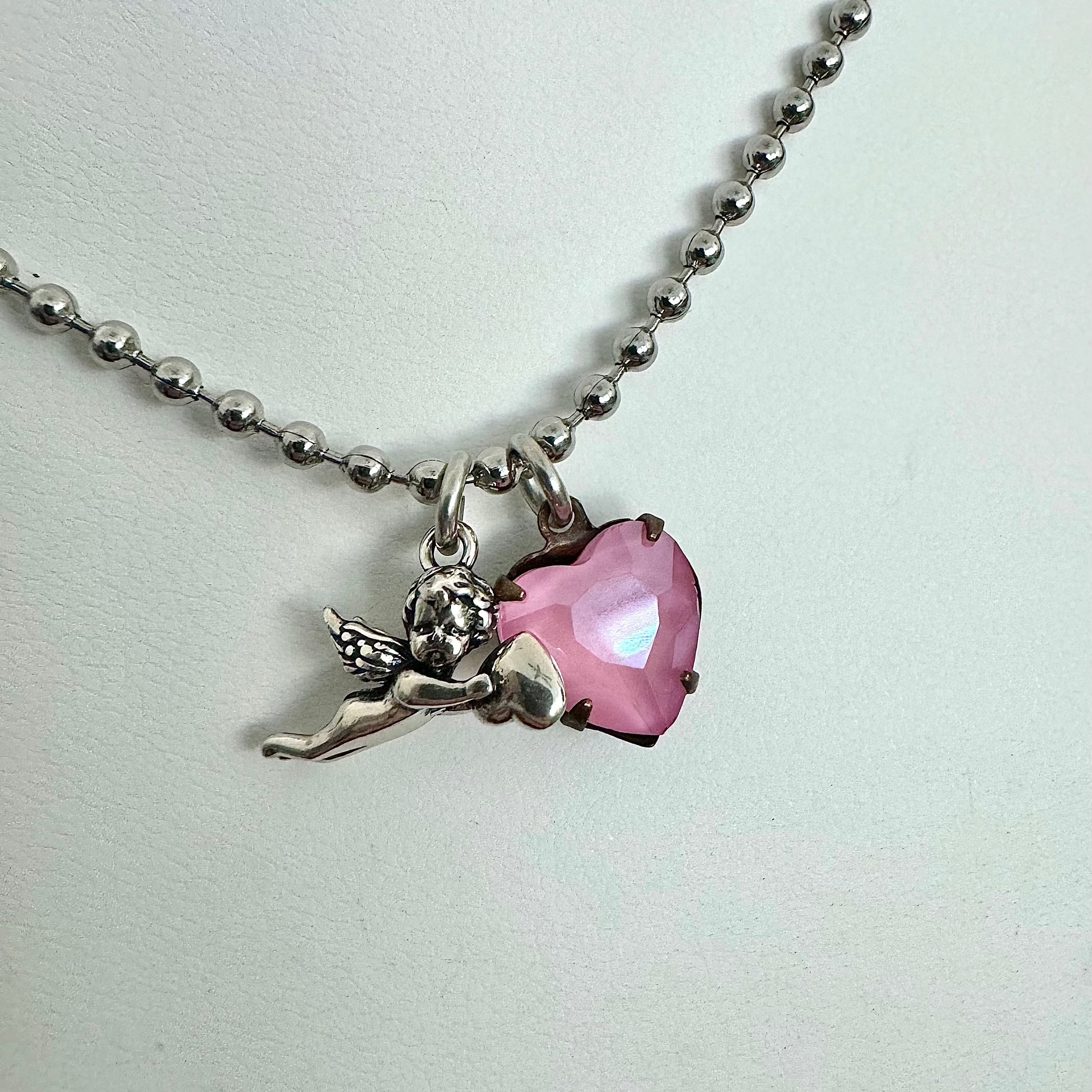 baby cupid necklace with heart charm up close view