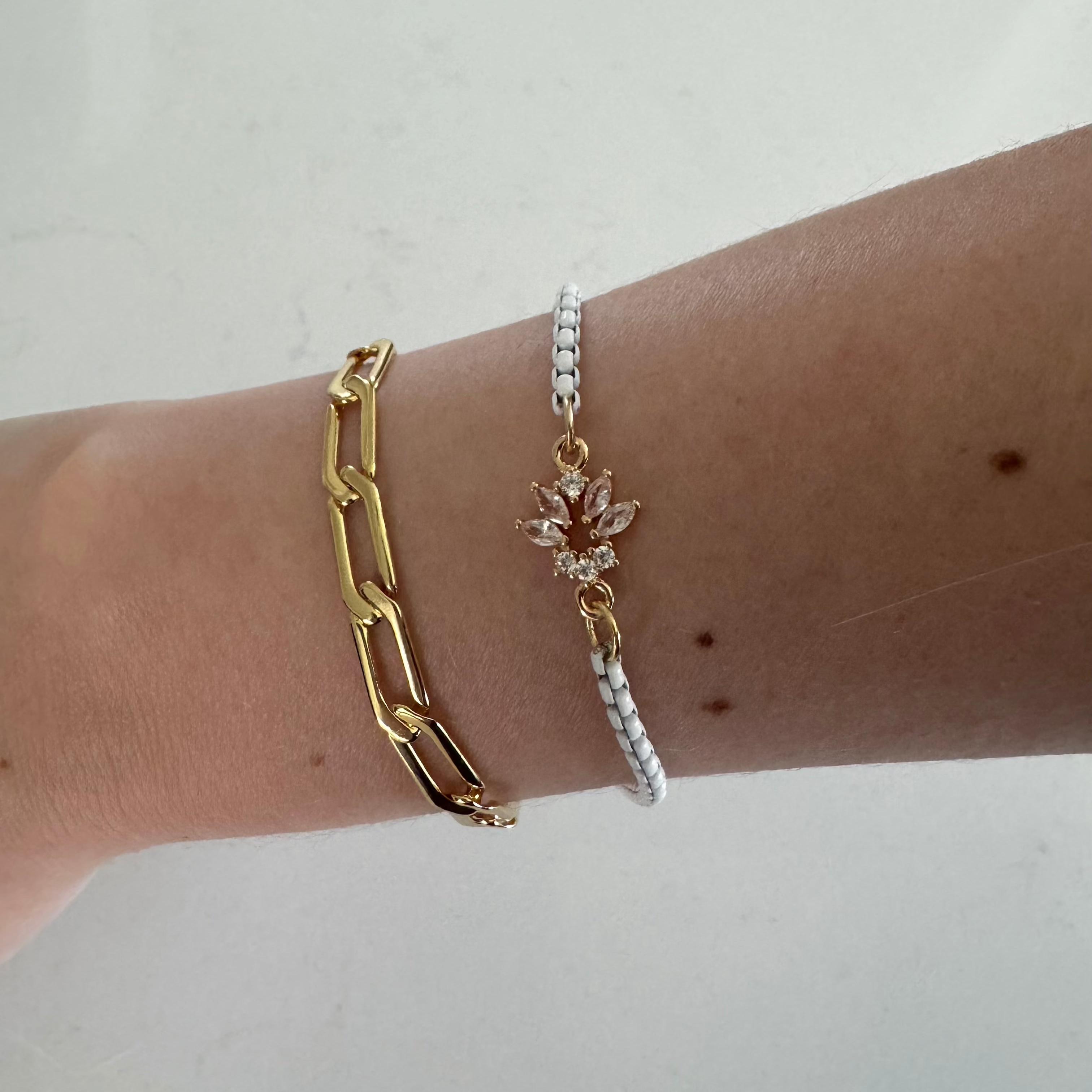 yacht club and paradise bracelets worn on wrist